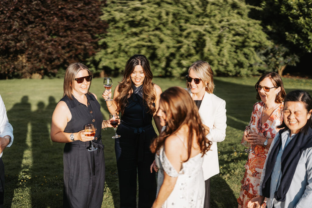 Guests enjoying an intimate wedding reception in the gardens at Nettlestead Place